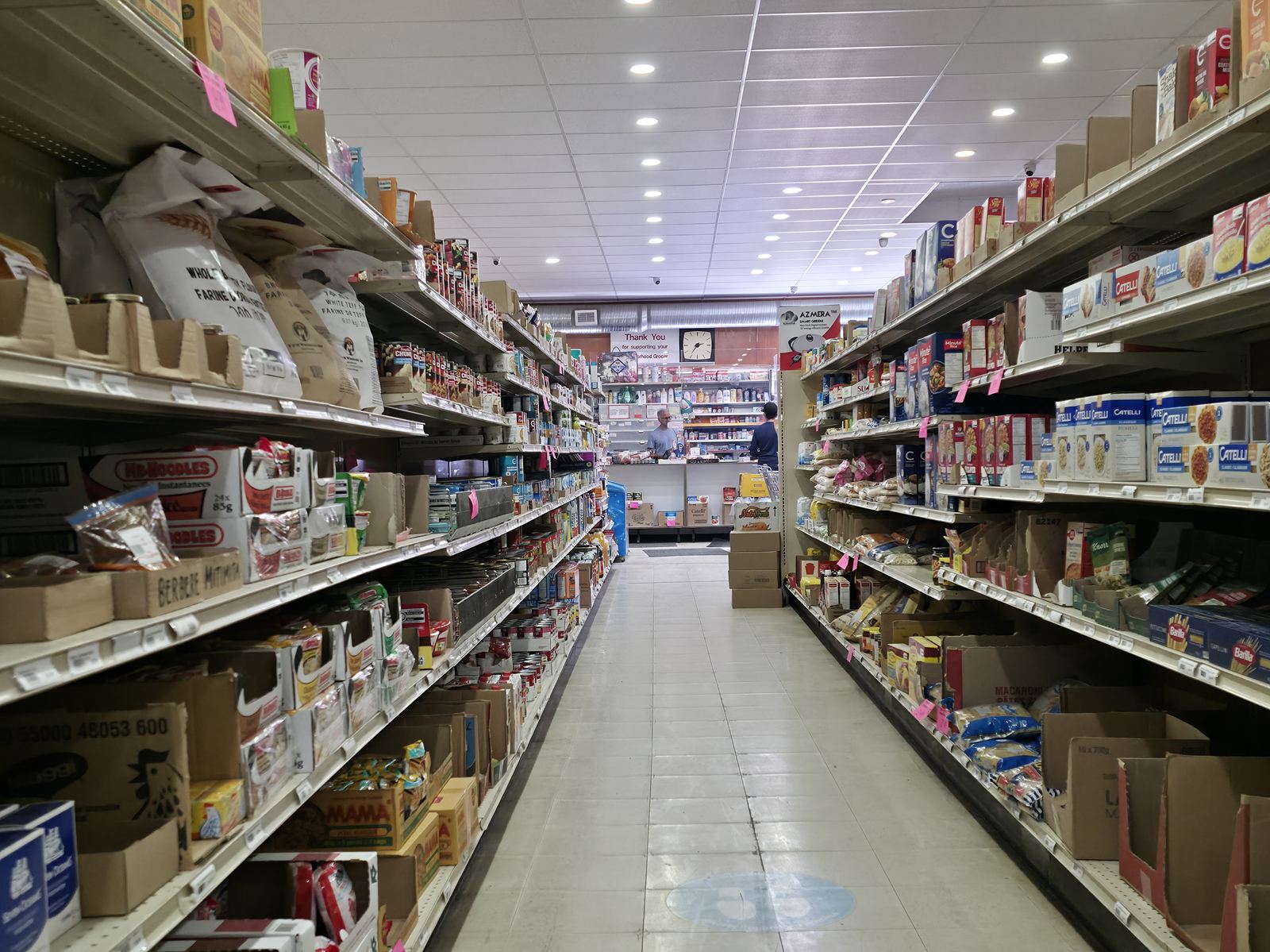 Grocery aisle at Abbi's Payfair stocked with pasta, rice, and pantry staples