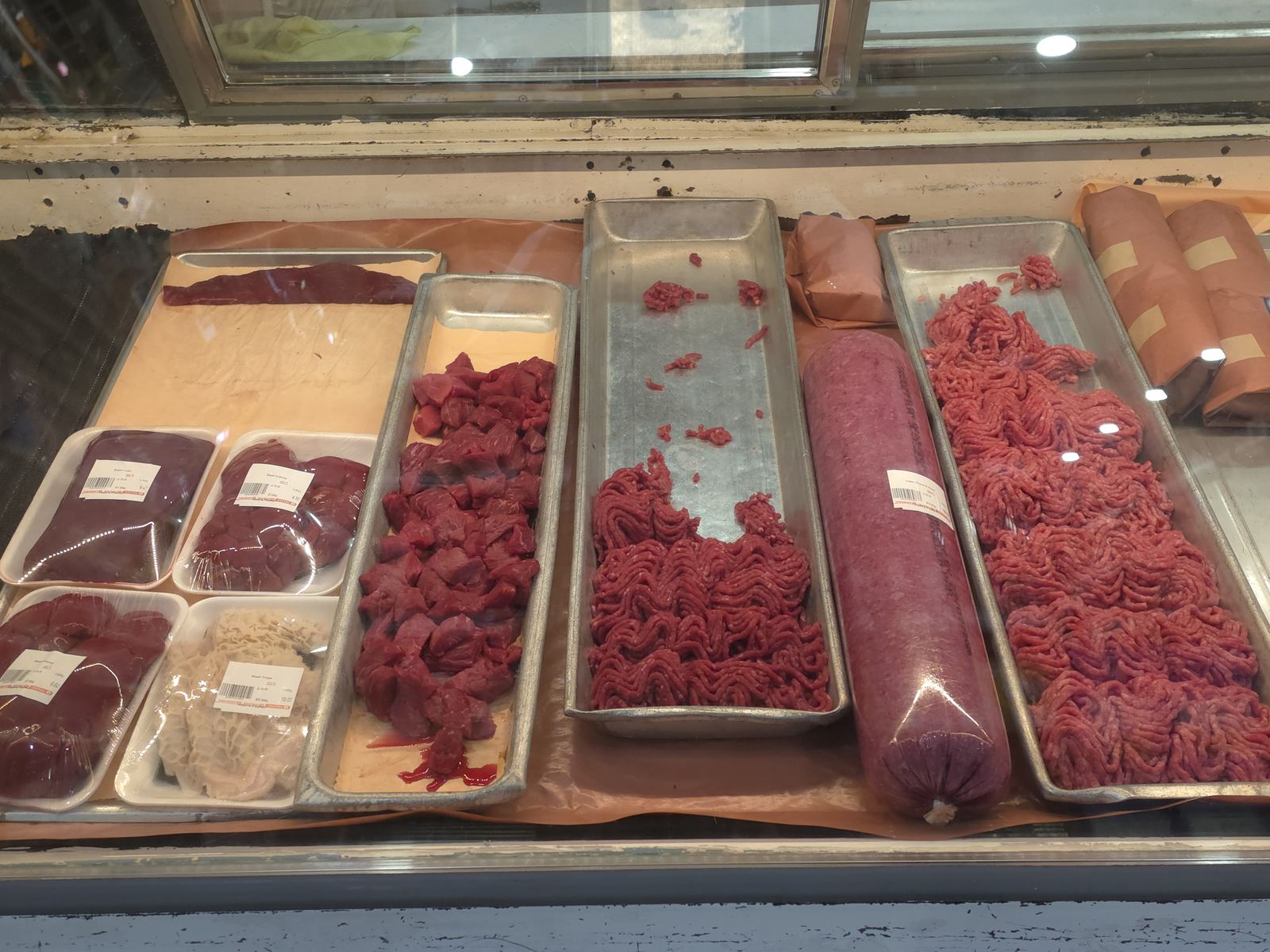 Deli case at Abbi's Payfair with bologna, ham, and sausages